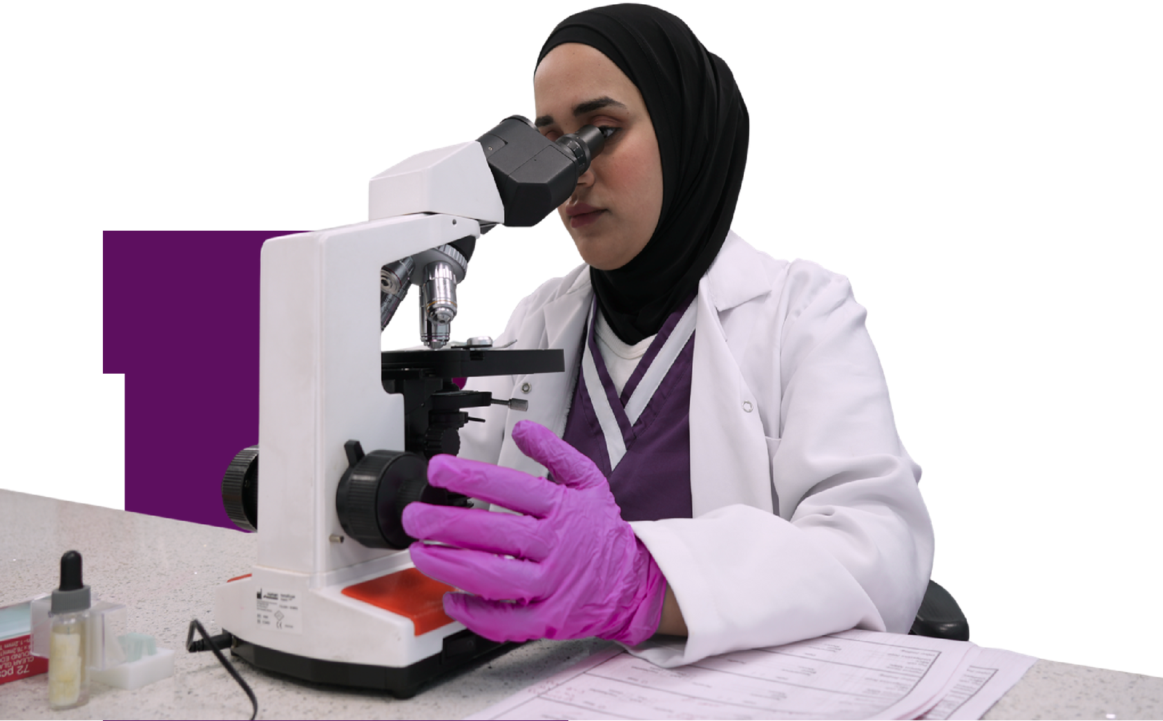 Researcher using microscope